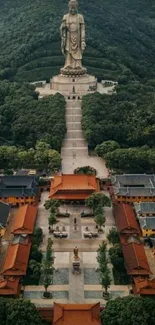 Aerial view of a majestic Buddhist statue surrounded by lush greenery.