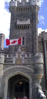 Stone castle with Canadian flag and blue sky backdrop.