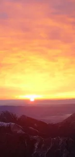 Sunrise casting orange hues over jagged mountain peaks.