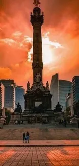 Majestic sunset silhouette of city angel monument with vibrant orange sky.