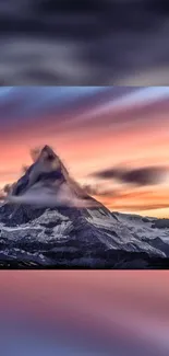 Snow-capped mountain under vibrant sunset sky.