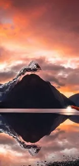 Majestic mountain at sunset with vibrant sky and reflection in water.