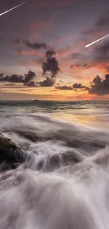 Sunset over ocean with vibrant clouds and waves.