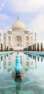 Taj Mahal reflected in tranquil water with a blue sky backdrop.