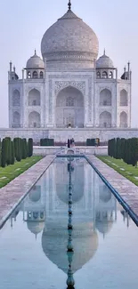 Majestic view of Taj Mahal with reflection pool and lush gardens.