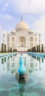 Majestic view of the Taj Mahal reflecting on clear water with a serene blue sky backdrop.