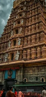 Majestic temple tower with intricate carvings against a dramatic sky.