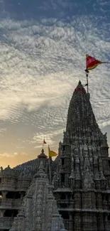 Historic temple silhouetted against a vibrant sunset sky.