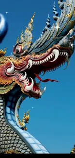 Vibrant Thai dragon in blue sky wallpaper art.