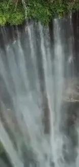 Aerial shot of a majestic waterfall cascading down cliffs.