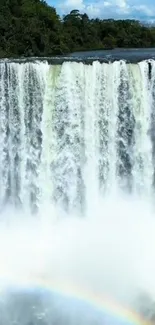 Majestic waterfall with a rainbow arcing across the scene.