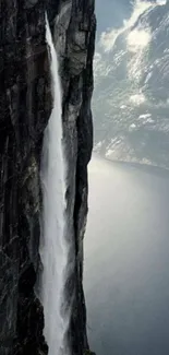 Majestic cliffside waterfall with scenic view.