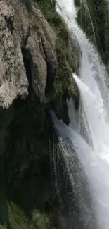 Majestic waterfall cascading over cliffs in a serene nature setting.