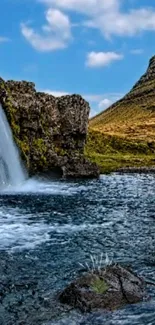 Majestic waterfall and mountain landscape on a clear day.