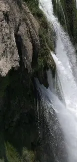 A breathtaking waterfall cascades over lush green cliffs.