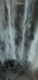 Waterfall cascading over rocks in nature scene.