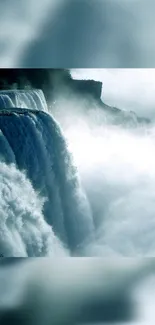 A majestic waterfall with mist in blue hues cascading down rocks. Perfect as a wallpaper.