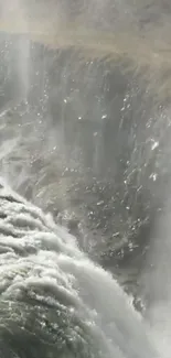 Waterfall cascading over cliffs in nature scene.