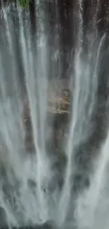 Majestic waterfall with cascading water and lush greenery.