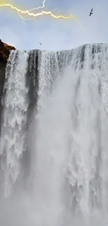 Dramatic mobile wallpaper of a waterfall with lightning in the background.