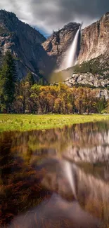 Waterfall cascading down cliffs into a reflective forested lake.