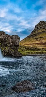 Majestic waterfall with mountain in serene landscape wallpaper.