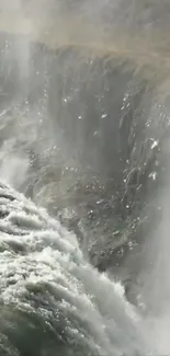 Majestic waterfall cascading down rocky cliffs, creating a dynamic nature scene.