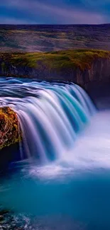 A breathtaking waterfall with vibrant blue water and lush green surroundings.