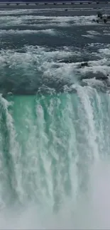 Majestic waterfall with turquoise waters cascading over rocks.