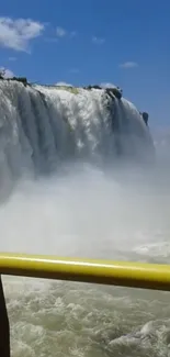 Majestic waterfall with clear blue sky in a serene natural setting.