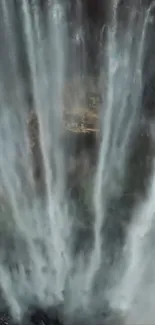 Majestic waterfall cascading down rocks, creating a serene natural scene.