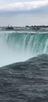 Stunning view of a majestic waterfall with cascading water and scenic surroundings.