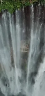 Majestic waterfall cascades down a lush cliff