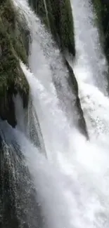 Beautiful cascading waterfall over rocks in a lush green forest.