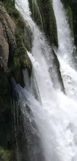 A stunning waterfall flows down amidst lush greenery.