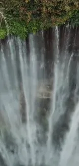 Stunning vertical waterfall with lush greenery in the background.