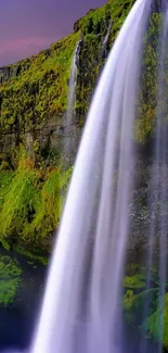 Majestic waterfall cascading down lush greenery with a vibrant purple sky.