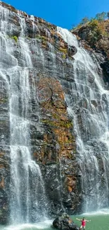 Cascading waterfall with blue sky background.