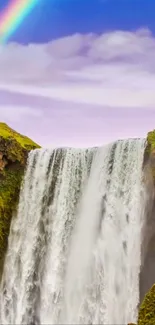 Majestic waterfall with a rainbow over lush green cliffs, perfect for mobile wallpaper.