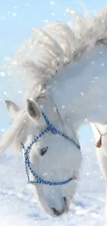 Majestic white horse in snowy winter scene with falling snow.