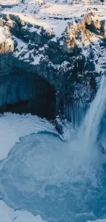 Frozen waterfall in snow-covered landscape.