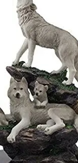 Gray wolf family sculpture on rocky terrain with nature details.