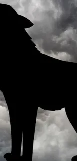 Majestic wolf silhouette against a dramatic cloudy sky wallpaper.