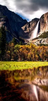 Yosemite waterfall with forest and reflection in tranquil landscape.