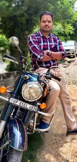 Man posing confidently on a classic motorcycle with a green background.