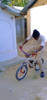 Man riding a bicycle on a sandy trail.