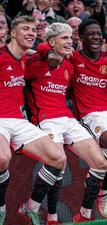 Soccer team celebrating in red jerseys.