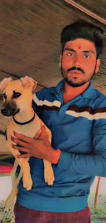 Man holding a cute puppy in an outdoor setting with warm tones.