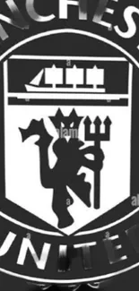 Manchester United FC crest in black and white, featuring iconic emblem design.