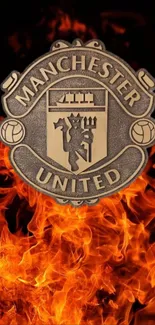 Manchester United logo with fiery flames background.